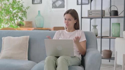 Young Woman Video Calling on Laptop at Home