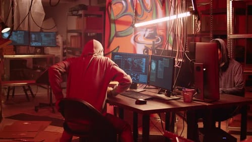 Two People Hacking Computers in an Urban Setting