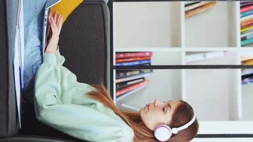 Young Woman Works on Laptop While Lying Down