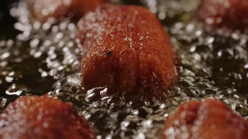 Portuguese Spanish Croquettes Boiling on Black Frying Pan Closeup Macro Breaded Croquette of Fish