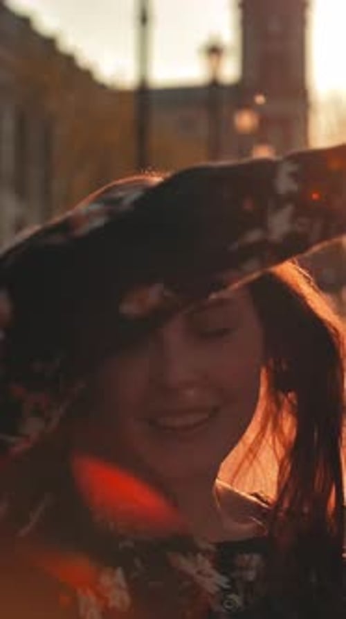 Lovely Couple Embracing and Smiling in City at Sunset