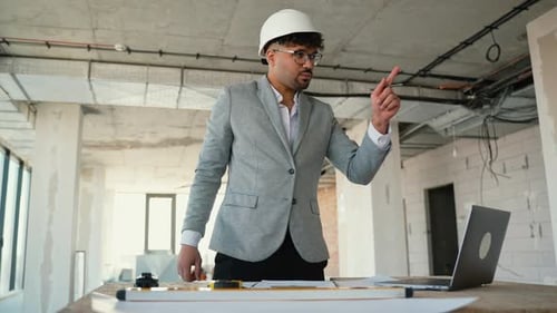 Architect Explaining Project Details During Online Meeting in Building Under Construction
