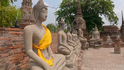 Row Of Buddha Statues At Wat Yai Chai Mongkhon, Buddhist Temple In Ayutthaya, Thailand. - wide shot