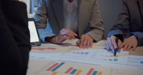 Business Team Analyzing Financial Charts in Office