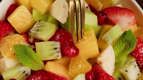 Close Up of Colorful Fruit Salad Being Eaten