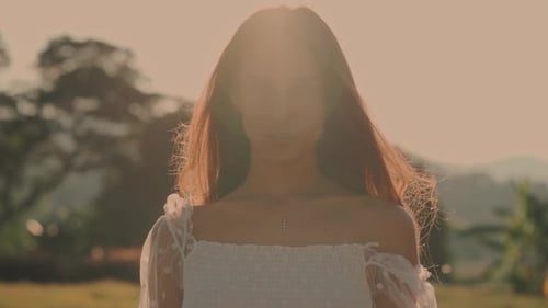Woman in White Dress Posing at Sunset