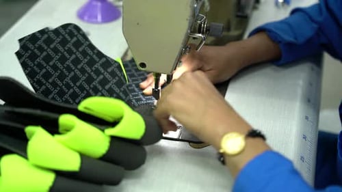 Female Hands Sewing in Factory