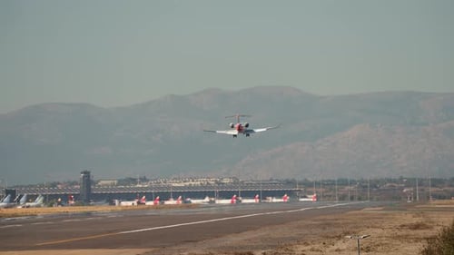 Commercial Jet Landing at Airport with Mountains
