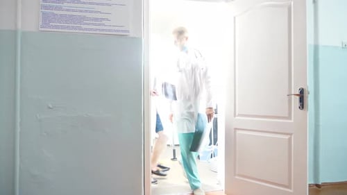 Two Male Caucasian Doctors Come Out Cabinet and View Mri Picture Showing Something on Xray to Each