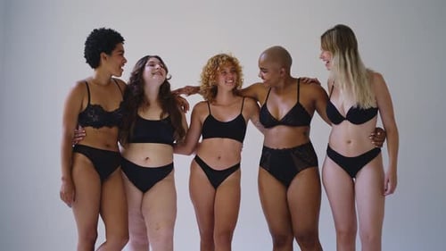 Smiling Women in Underwear Posing Arm in Arm