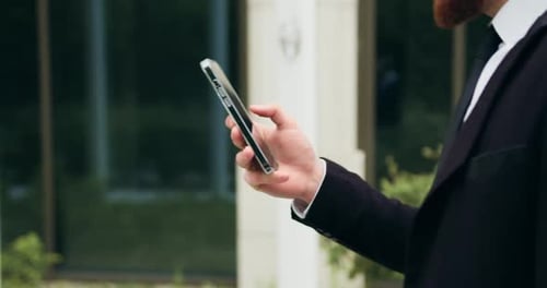 Close up hands of man typing a text message or networking on social media. Technology, outdoor