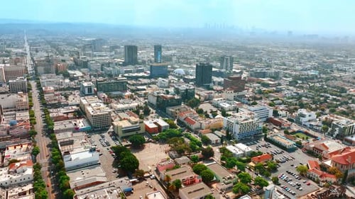 Urban landscape of modern Los Angeles, California, USA. City at backdrop is covered with thick fog.