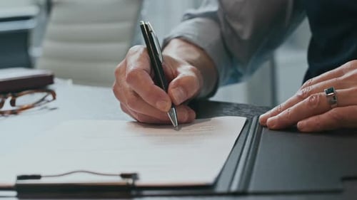 Hands of Unrecognizable Businessman Signing Contract at Office