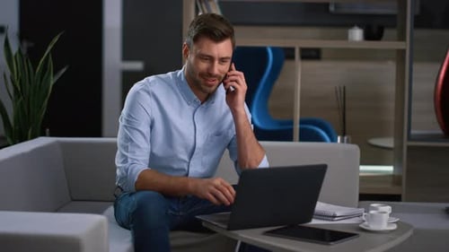 Professional Business Man Using Laptop Device Finish Cell Phone Call in Office