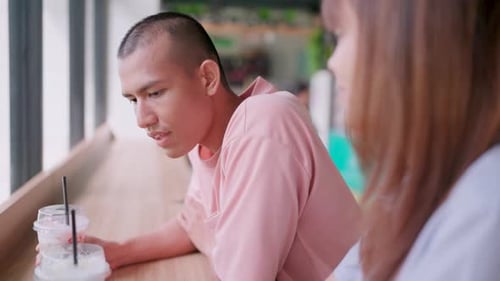 Close-up of a man looking at his lover using a smartphone to surf the internet.