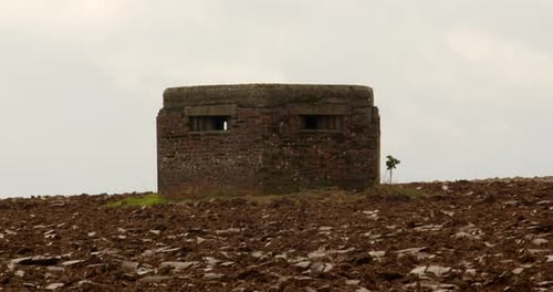 Weathered Brick Bunker in Empty Field