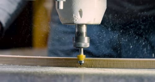 Woodworker Using CNC Router To Cut Wooden Piece