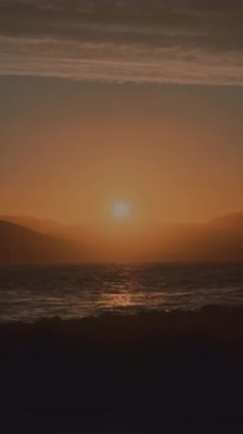 Foggy view of orange sky at sunset on the coasts