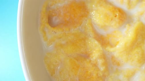 Top view of Appetizing corn flakes mixed with milk