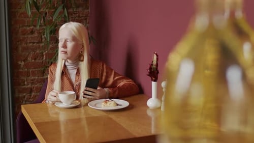 Young Woman With Albinism In Cafe