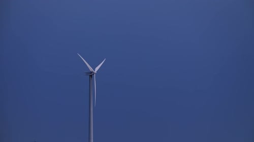 Rotating Wind Turbine Against a Blue Sky