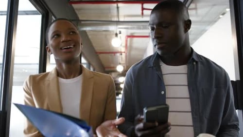 Diverse business people talking and walking in office, slow motion, copy space