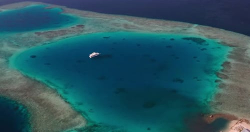 Aerial view of a scenic landscape of desert island with white sand beach, crystal clear sea water
