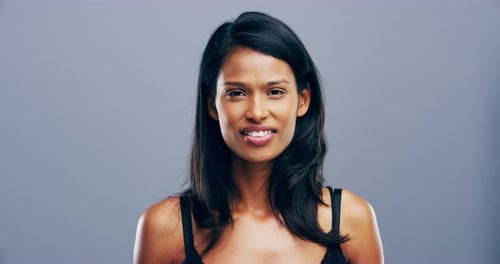 Smiling Woman Makes Heart Shape with Hands