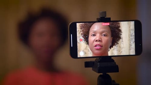 Woman Recording Herself with Smartphone for Makeup Tutorial