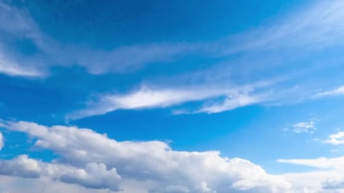 Clouds Moving Across the Blue Sky in Daytime