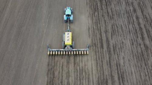 Blue tractor OA working on the field in Ukraine