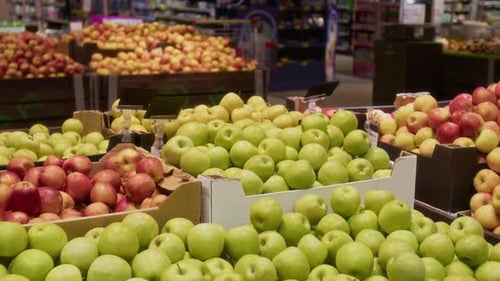 Assortment of Fresh Green and Red Apples Neatly Arranged in Cardboard Boxes