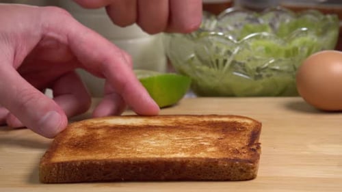 Preparing Fresh Avocado Toast for Breakfast