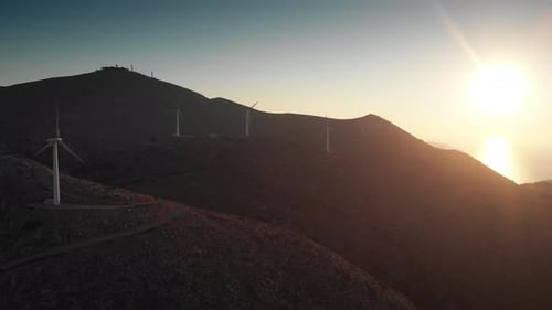Modern power turbines on top of mountain against sky