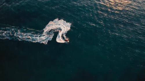 Jet ski performing a turn in serene ocean waters