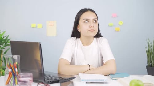 Stressed Woman at Desk With Laptop