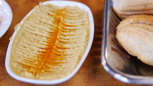 Enjoying Traditional Hummus with Fresh Bread at a Local Restaurant