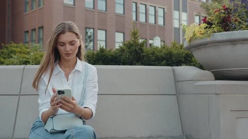 Portrait of Business Woman Typing By Mobile Phone Outdoors
