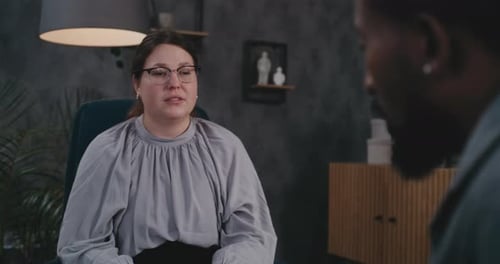Woman Speaking to Man in Office