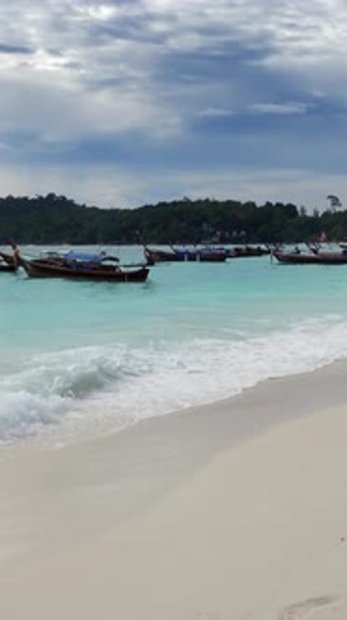 Waves on beach with white sand