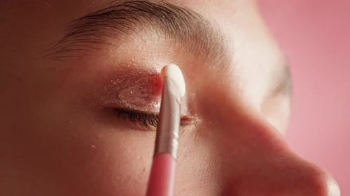 Eye Shadow Makeup to the Upper Eyelid Closeup Makeup Artist Applies a Bright Eye Shadow with a