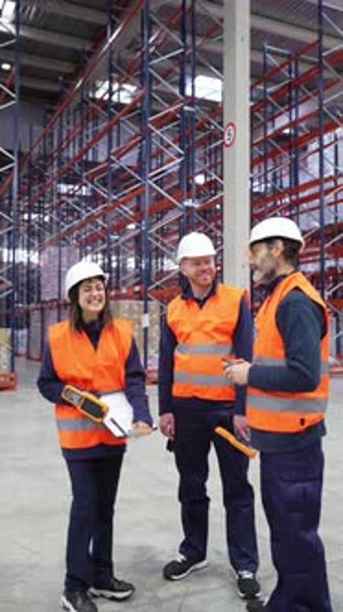 Warehouse Workers Discussing Logistics and Inventory Management