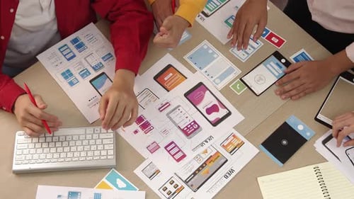 Top view of startup employee designing user interface for application. Synergic
