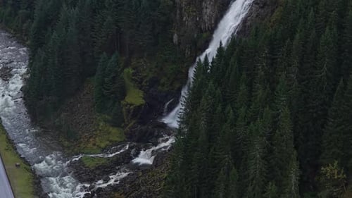 Aerial shot of Norway Latefossen waterfall amid lush green forest