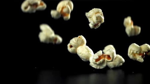 Popcorn Falls on the Table On a Black Background Filmed on a Highspeed Camera at 1000 Fps