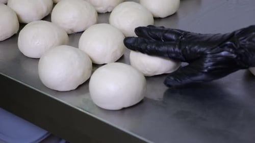 Closeup of the Cook Preparing Dough for Buns in the Restaurant's Kitchen