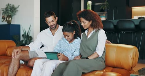 Family Relaxing on Couch with Tablet