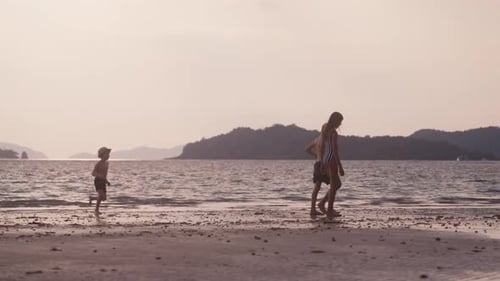 Boy Running Toward The Kids On The Beach