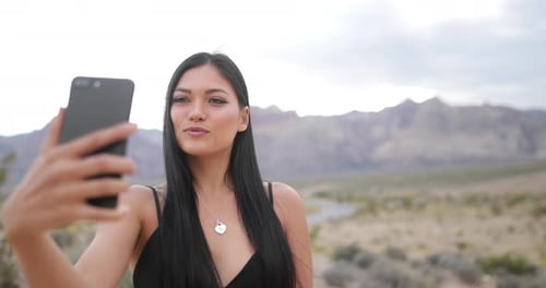 Woman taking selfie in desert