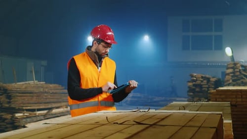 The Ingineer Works in a Warehouse Uses a Tablet